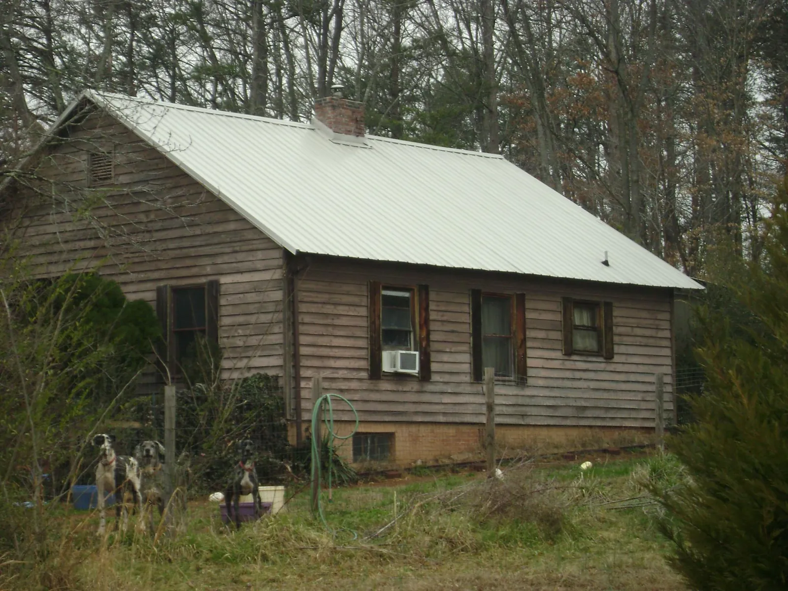 White metal roof on an old wood sided farmhouse, from a Metal Roof Installation job in Warm Springs